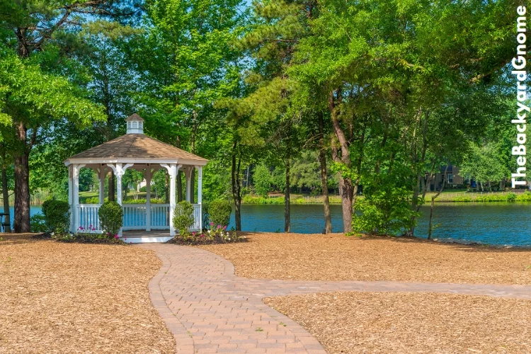 A beautiful white gazebo in a blooming garden